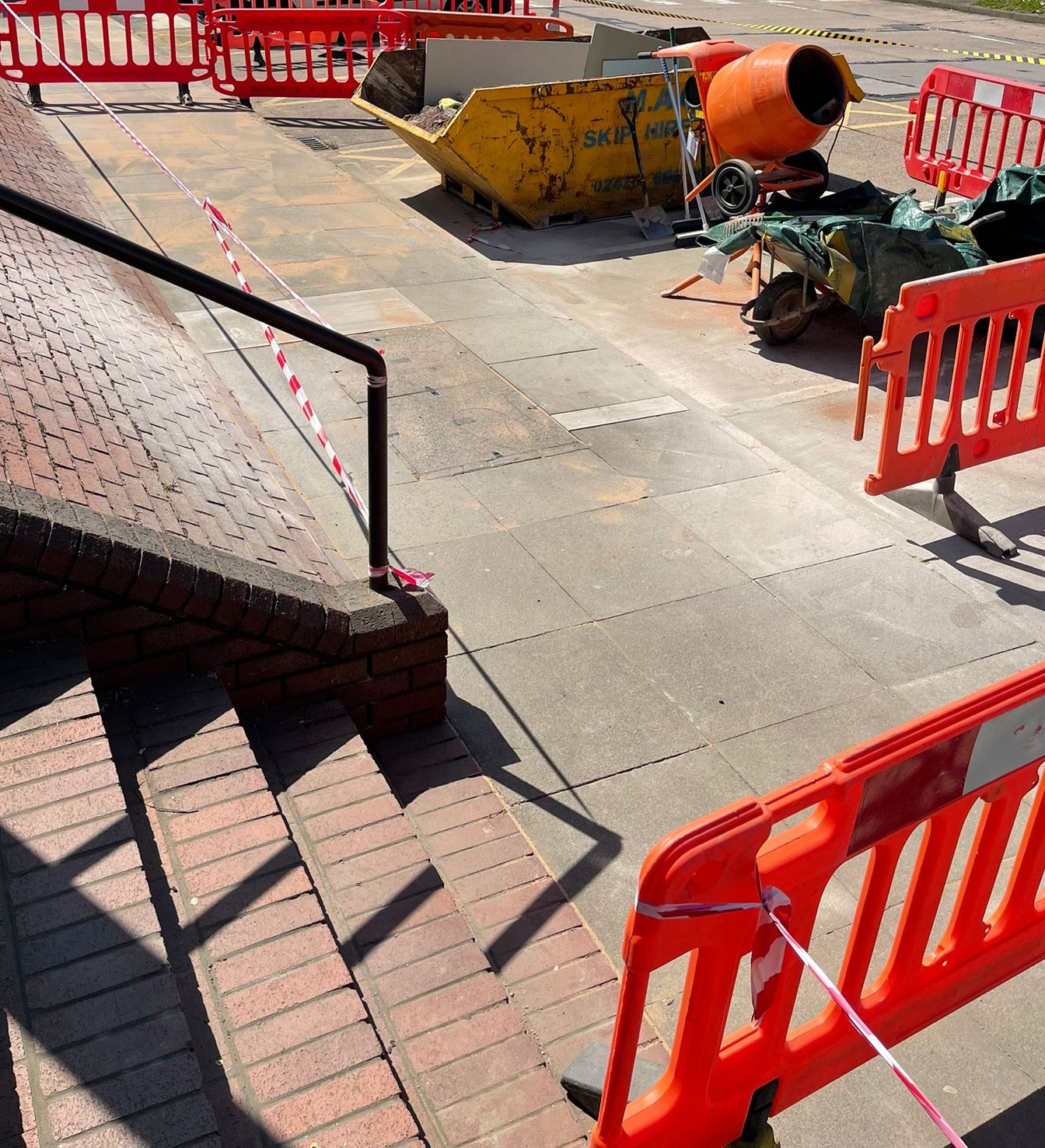 Paving slab repair work area in Coventry during commercial external maintenance