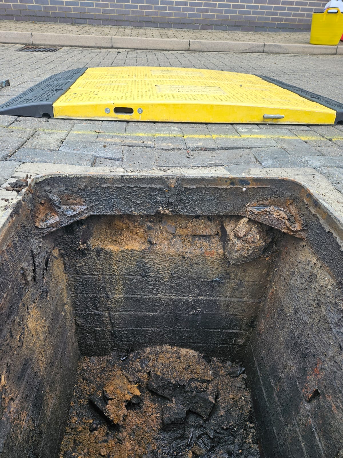 Open manhole chamber during replacement works at a commercial site in Nottingham